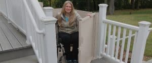 woman on wheelchair getting out of residential platform lift