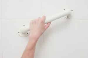 woman grabbing bar on bathroom