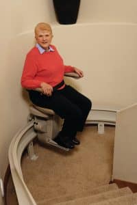 woman using curved stair lift