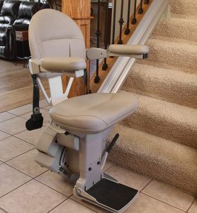 indoor stair lift unfolded at bottom of stairs