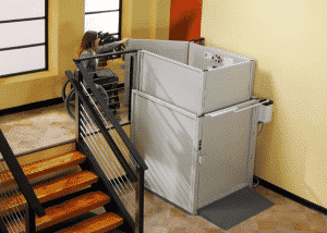 woman in wheelchair using vertical commercial platform lift