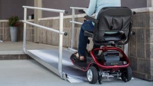woman on scooter using semi permanent residential ramp