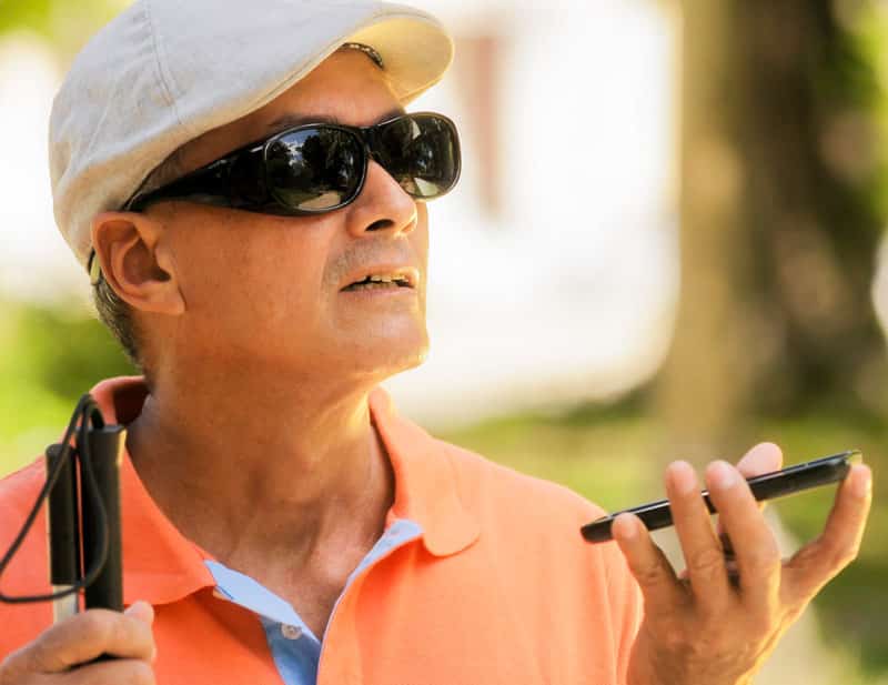 visual impaired man using cellphone. voice search