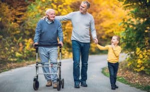 senior using mobility device with family