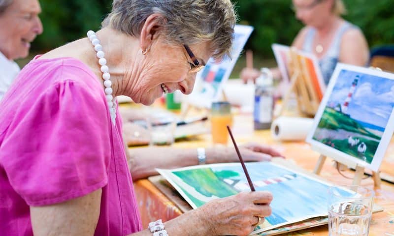 senior woman painting activity group