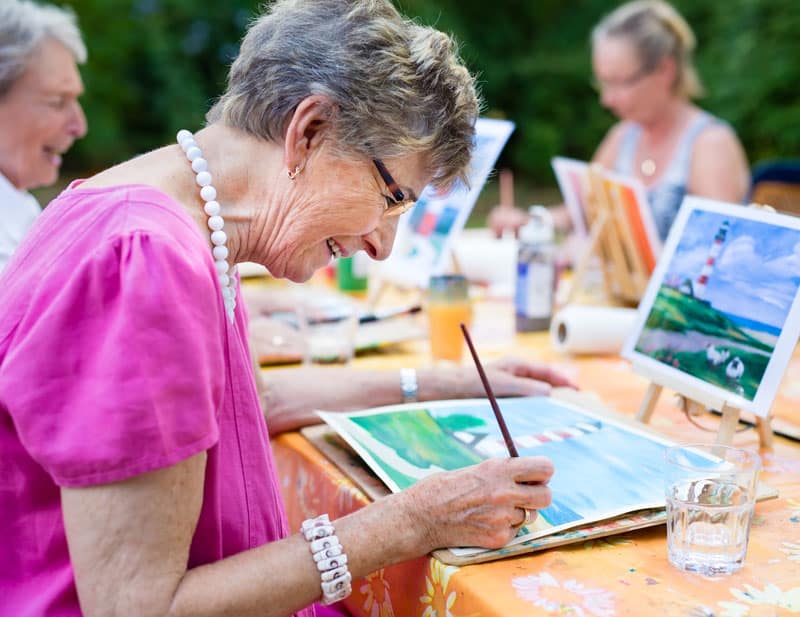 senior woman painting activity group