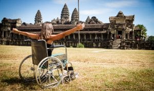 woman in wheelchair infront ancient temple