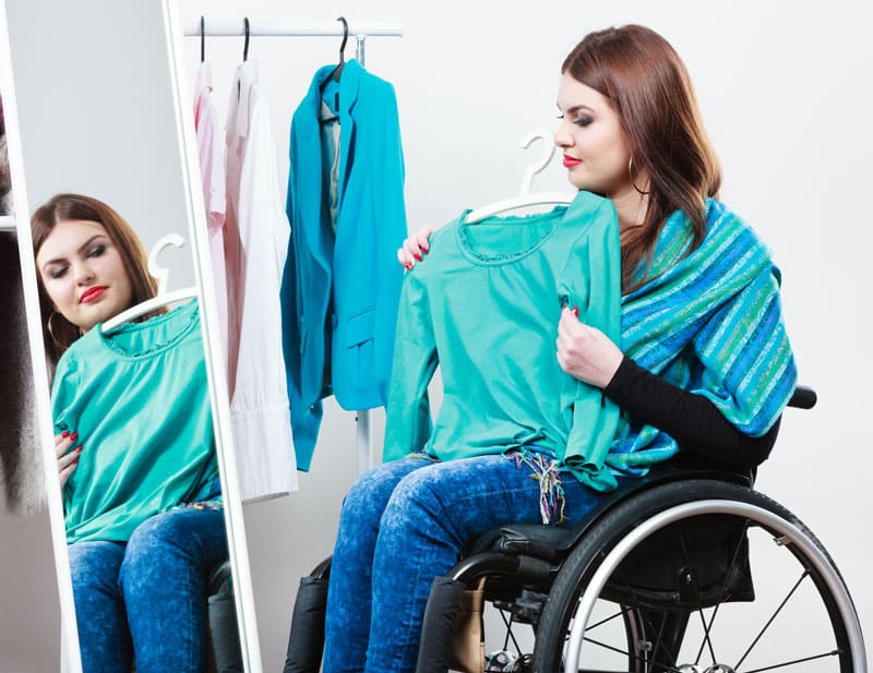 woman in wheelchair choosing clothes