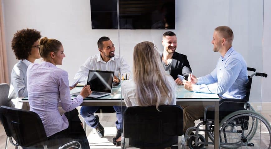 man in wheelchair during business meeting