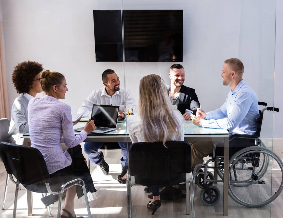 man in wheelchair during business meeting