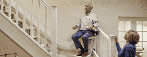 man using stair lift at home